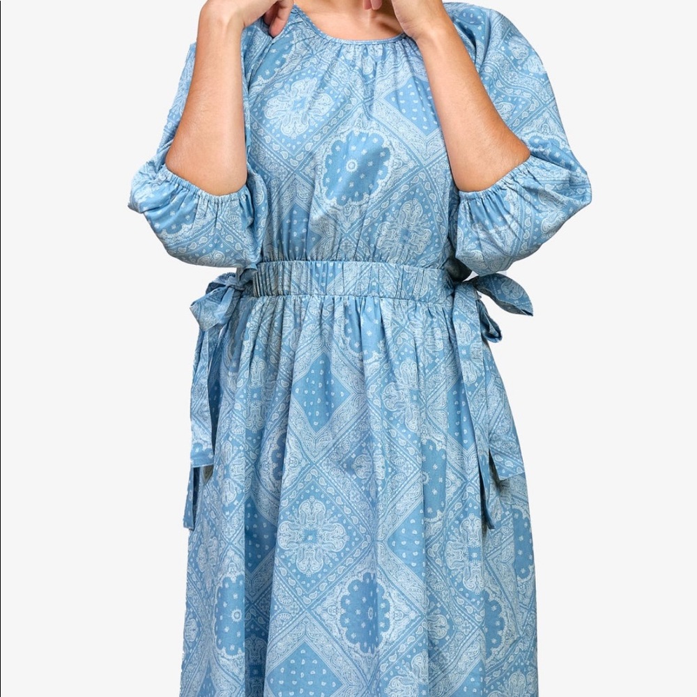 Cute blue sun dress with sinched waist and ties on each side.